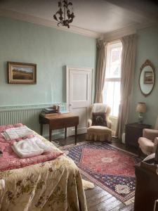 1 dormitorio con 1 cama, 1 silla y 1 ventana en The Old Bakehouse, Walsingham, en Little Walsingham