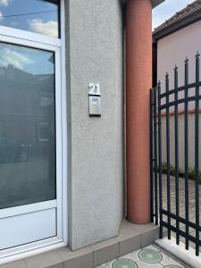 a door with a sign on the side of a building at Apartman Jovana 2 in Jagodina