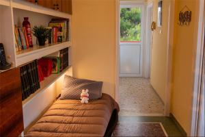 a room with a couch with a teddy bear sitting on it at Zoumperi Nea Makri 4-5 guest apt big balconies 5 min to beach in Nea Makri