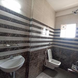 a bathroom with a sink and a toilet at PREMIER INN LODGE in Mangalore