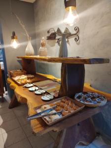 a table with various pastries and a cross on it at Kastel Jampa Hotel in João Pessoa