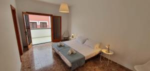 a bedroom with a large bed and a large window at Casa Andrea Teror in Teror