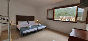 a bedroom with a bed and a large window at Casa Andrea Teror in Teror