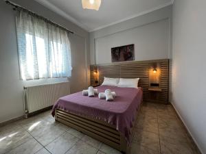 a bedroom with a bed with two towels on it at PanDora Apartments in Moudhros