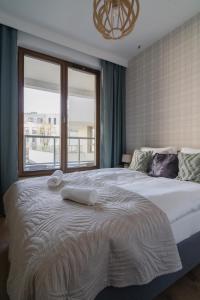 Łóżko lub łóżka w pokoju w obiekcie TOTU HOME Garnizon Apartament Hemara 11