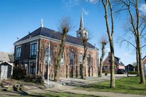 a large brick church with a steeple at B&B Zijlsterkerk 