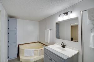 a white bathroom with a sink and a mirror at Fire Pit and Deck Peaceful Silver Creek Retreat in Prentiss +27 photos