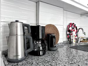 a kitchen counter with a coffee maker on a counter top at Kaş Merkezde Konforlu Apart-2 The Rush-2 in Kas