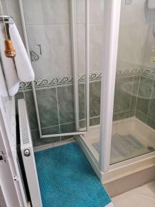 a shower with a glass door in a bathroom at Shielded Serenity - 3 BR House in South Shields