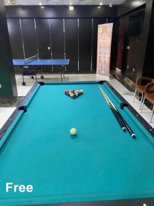 a pool table with a ball on top of it at Holiday Furnished Units in Dammam