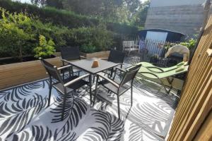 a patio with a table and chairs on a balcony at Studio cocooning in Le Porge