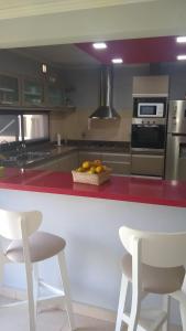 a kitchen with a counter with a bowl of fruit on it at Home J y M in Concordia