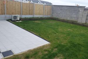 a backyard with a lawn and a fence at Abbeyfort Kinsale in Kinsale