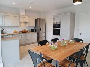 a kitchen with a wooden table and some chairs at Abbeyfort Kinsale in Kinsale