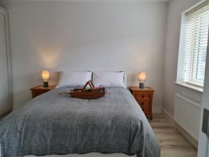 a bedroom with a bed with a bowl of fruit on it at Abbeyfort Kinsale in Kinsale