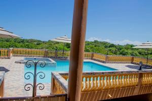 a view from a balcony of a swimming pool with umbrellas at Blue Berry Hill Villa in Discovery Bay