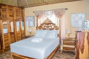 a bedroom with a large bed and a window at Blue Berry Hill Villa in Discovery Bay