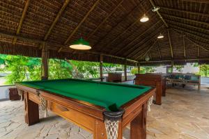 a pool table in the middle of a room at Pousada Corsario Paraty in Paraty