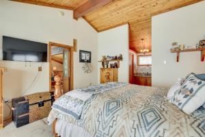a bedroom with a bed and a wooden ceiling at Cozy Mountain Home on 10 Acres with Fire Pit and Games in Thayne