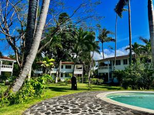 a man standing in front of a resort at Beautiful 1 Bedroom Apartment in Paradise / WIFI in Las Terrenas