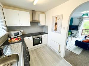 a kitchen with a sink and a stove top oven at 2 Bedroom Flat - Free Parking in Shenley Church End