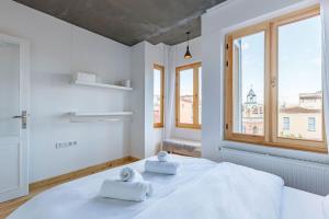 a white bedroom with two towels on a bed at Cozy in Istanbul