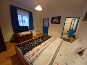 - une chambre avec un lit, une commode et un miroir dans l'établissement Casa Traditionala Clisciova, à Murighiol