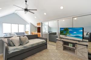uma sala de estar com um sofá e uma televisão de ecrã plano em 36 Courtside Near Ocean Forest Beach em Hilton Head Island