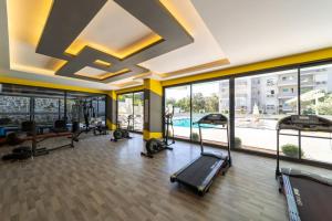 a gym with several treadmills and a large window at Modern Apartment with Shared Sauna in Alanya in Kargicak