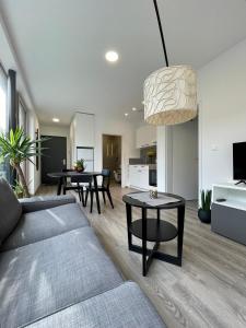 a living room with a couch and a table at Tea Apartment in Ljubljana