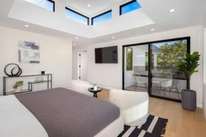 a bedroom with a large bed and a living room at Curson Modern in Los Angeles