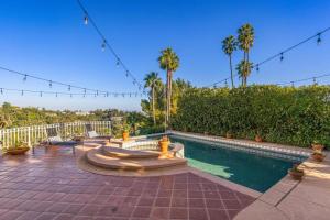 a swimming pool with a fountain and palm trees at Stradella in Los Angeles