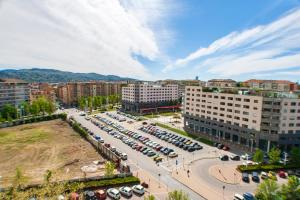 a parking lot with parked cars in a city at Attico con Vista in Turin