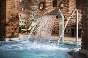 a water fountain in the middle of a building at Gościniec Ryński Młyn in Ryn