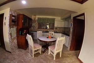 a kitchen with a table and chairs in a room at 2BHK Apartment In Mansion Near Nainital Lake in Nainital