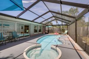 een zwembad in een huis met een glazen dak bij Seminole Vacation Rental with Heated Pool! in Seminole