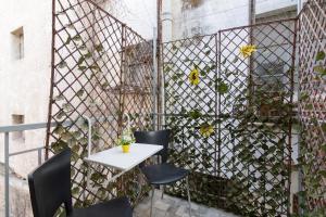 a patio with a table and chairs and a fence at Modern and Cute Studio in Athens