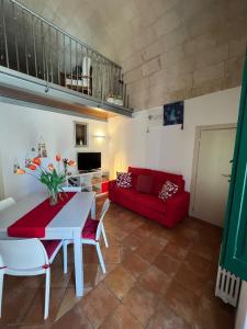 a living room with a red couch and a table at Il Mulino A Vento in Matera