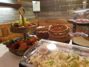 a buffet with bowls of fruits and vegetables on a table at Weingut Reiterer in Kitzeck im Sausal