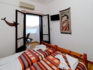 a bedroom with two beds and a window at Dolphins in Elounda