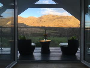 a room with a view of a mountain through a window at Invercreran Lodge Luxury Bed & Breakfast in Appin