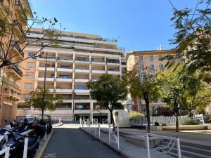 a parking lot in front of a large building at free parking, 2min walk to Monaco, 2 rooms, 100 mq in Beausoleil