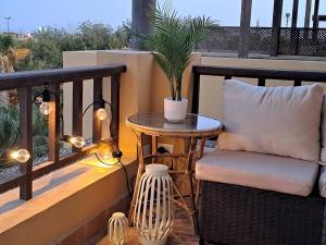 a table and a chair on a balcony with a plant at Luxury in the heart of Gouna in Hurghada