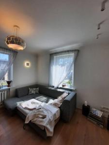 a living room with a couch and a bed at Cozy private house with a yard & parking in Rīga