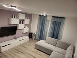 a living room with a couch and a flat screen tv at Haus für vier, kinderfreundlich! in Steinhagen