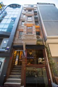 a tall building with stairs leading into a store at Galapera Hotel in Istanbul