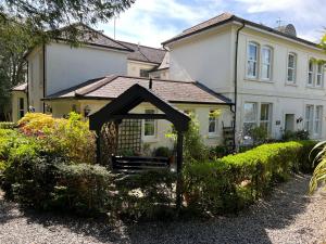 a house with a gate in front of it at Hollyhocks Holiday Home-Luxury ground floor 2 bedroomed apartment sleeps 5 in Ivybridge