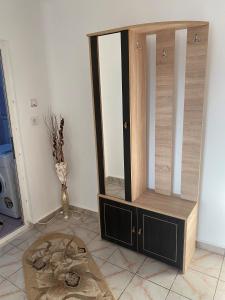 a wooden cabinet in a room with a rug at Waves of the Sea in Mangalia