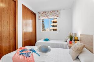 a bedroom with two beds and a window at Apartment Barlovento 2 - PlusHolidays in Calpe