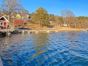 a view of a lake with houses and a dock at Holiday home INGARÖ VI in Lillängsdal